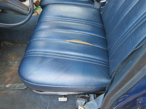 1991 Ford LTD Crown Victoria - Interior view of a car seat with a significant rip in the upholstery.