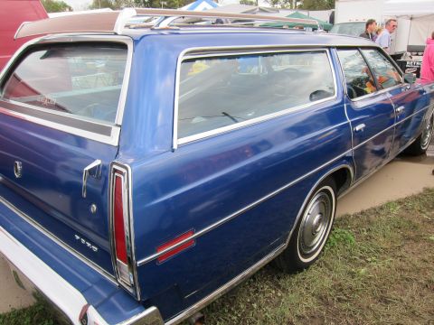 1991 Ford LTD Crown Victoria - Blue station wagon with chrome trim and a roof rack, seen from the side.
