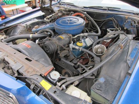 1991 Ford LTD Crown Victoria - A close-up view of the engine compartment, showing the air intake and associated plumbing.
