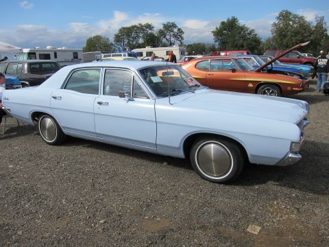 1991 Ford LTD Crown Victoria - A light blue 1970 Ford sedan is parked on a gravel lot, with other vehicles visible.