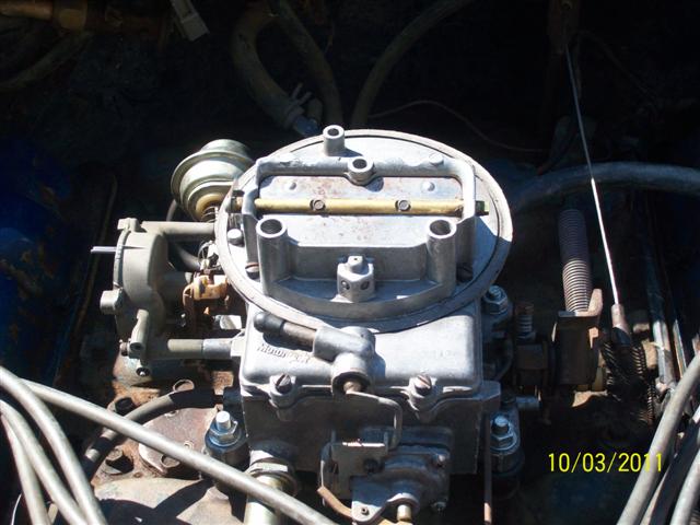 Carburetor with visible "Motorcraft" text, in engine bay