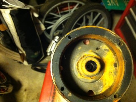 1999 Tomos Targa - A close-up view of a rusty engine component, with other items like wheels and bags blurred in the background.