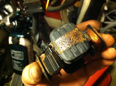 1999 Tomos Targa - A close-up view of a motorcycle ignition coil, showing signs of wear and corrosion on its components.