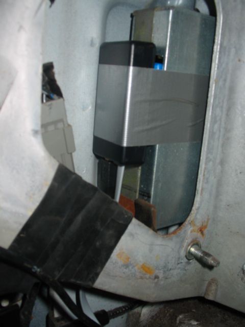 1992 Ford Bronco - An electronic module, wrapped in silver tape, is visible within a vehicle's interior compartment.