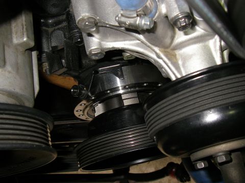 1990 Ford Bronco - Close-up view of engine pulleys and drive belt system components.