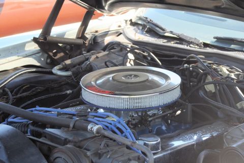 1976 Ford Ranchero - The engine bay of a 1976 Ford Ranchero is visible, showing the air cleaner and spark plug wires.
