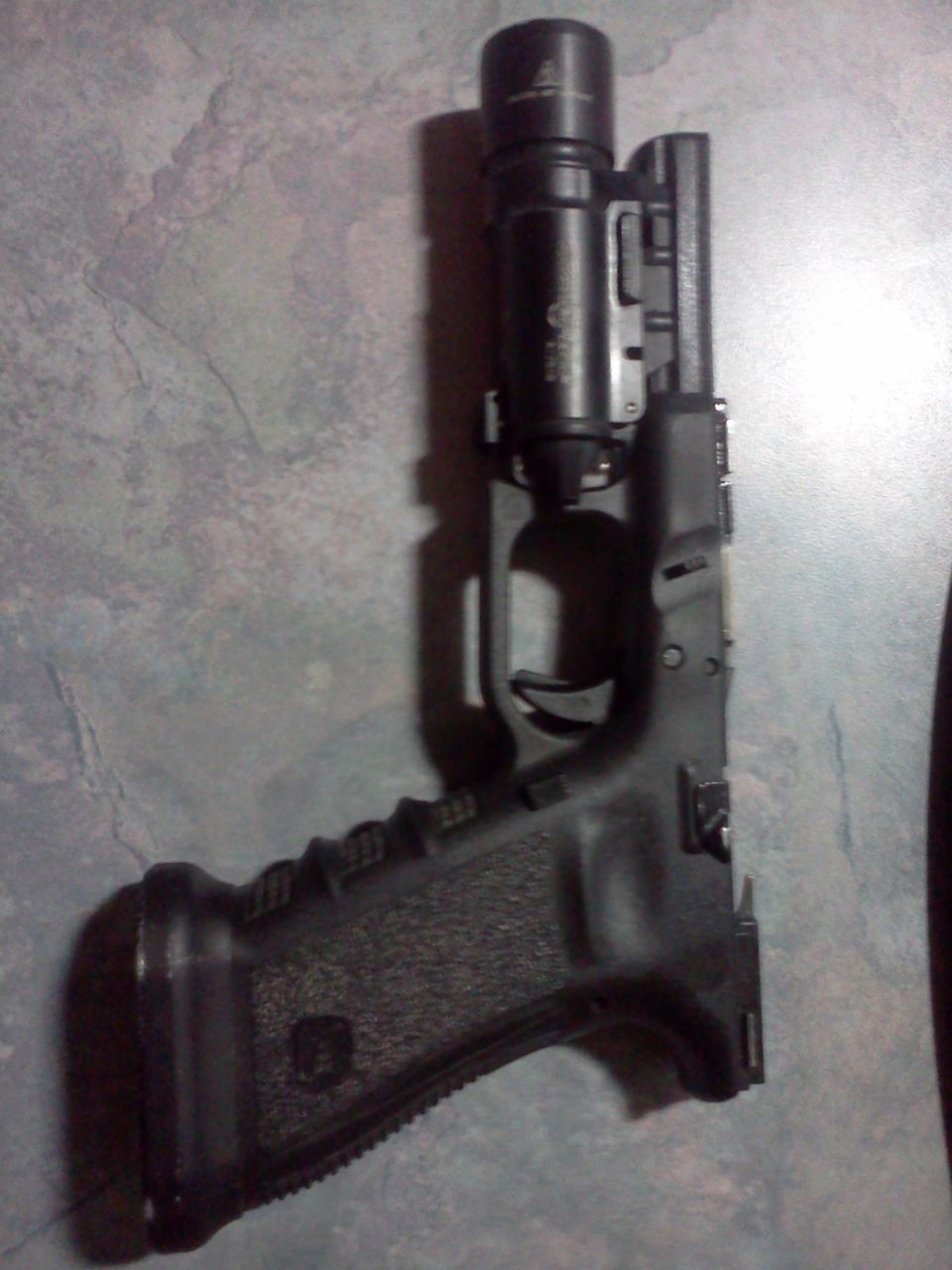 Pistol with mounted flashlight