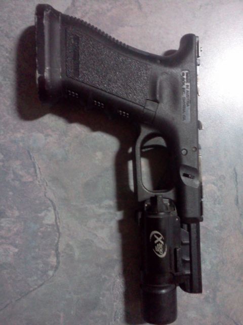1996 Ford Bronco - Pistol with a tactical light mounted on the accessory rail.