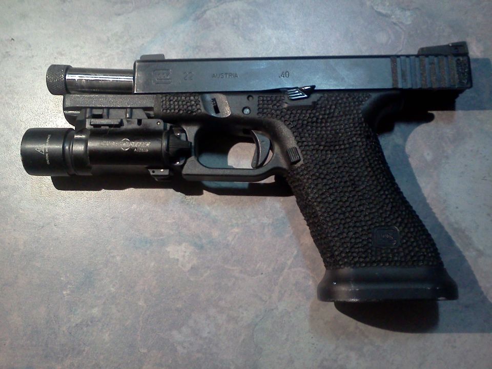 Glock pistol with SureFire light attached to the rail