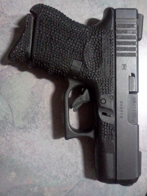 1996 Ford Bronco - A close-up view of a Glock pistol, showing its textured grip and slide details.