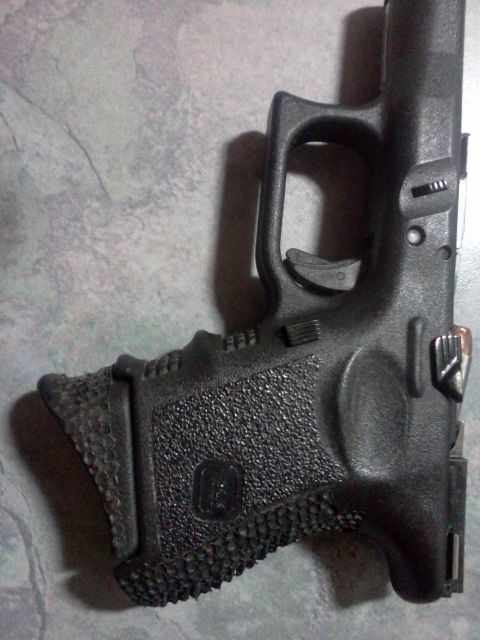 1996 Ford Bronco - Close-up view of the textured grip on a black Glock pistol.
