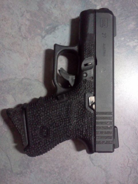 1996 Ford Bronco - Glock 27 pistol with textured grip and slide markings.