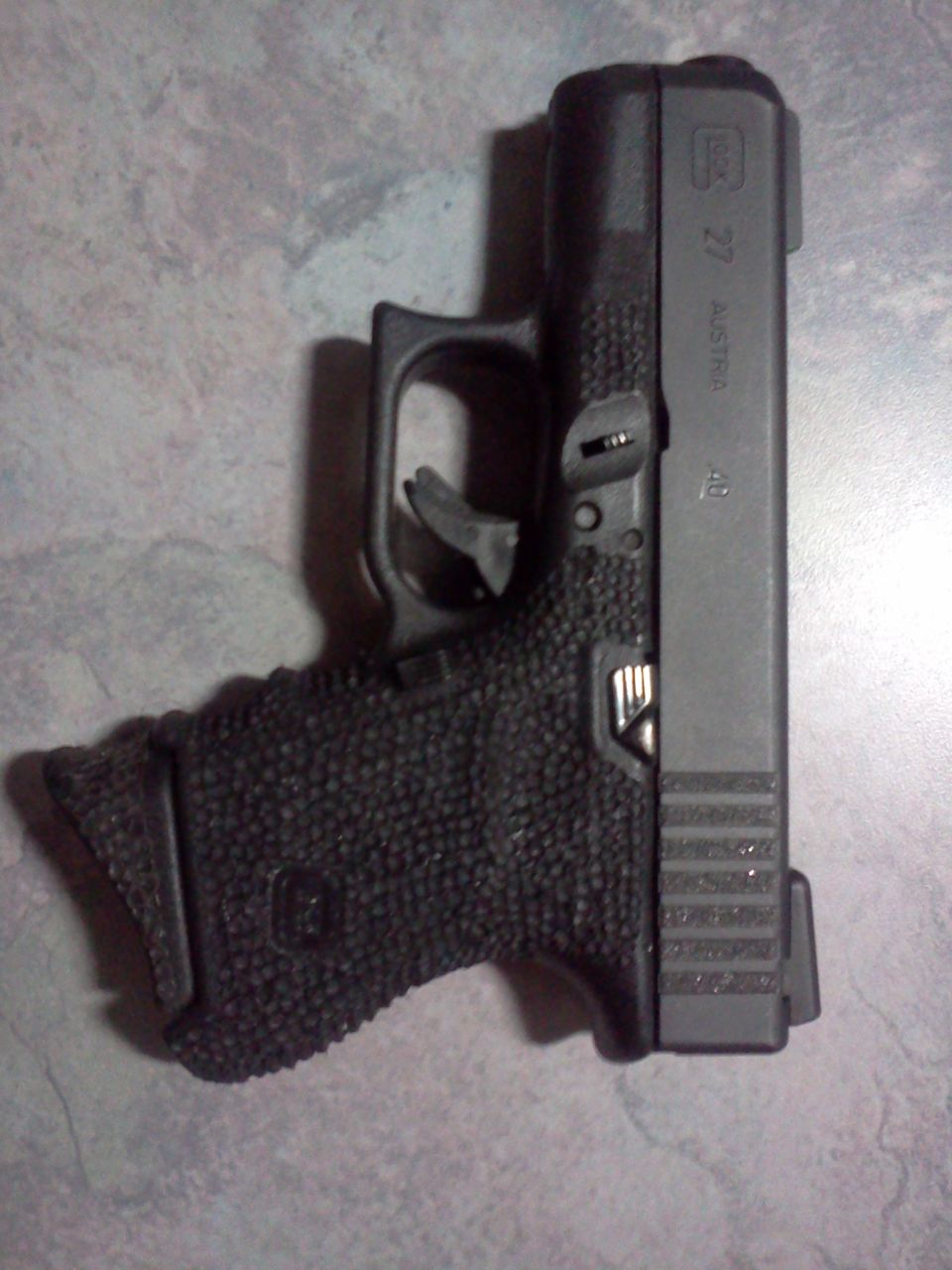 Glock 27 pistol with textured grip
