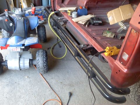 1978 Ford Bronco - An ATV and power tools are in the bed of a red vehicle, which has black running boards. The image includes a "SUPERMOTORS.NET" watermark.