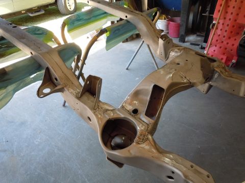 1973 Pontiac Trans Am - A vehicle frame is shown on stands, likely undergoing restoration work in a garage setting.