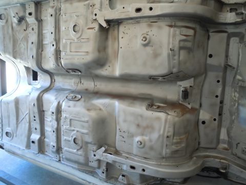 1973 Pontiac Trans Am - The underside of a vehicle, revealing its structural components and signs of wear.