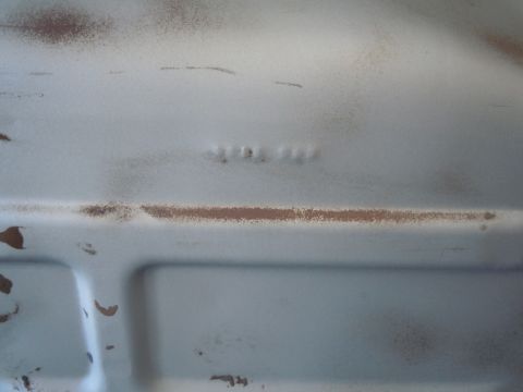 1973 Pontiac Trans Am - Close-up view of stamped numbers on a light blue metal surface, showing signs of rust.