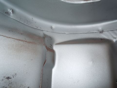 1973 Pontiac Trans Am - Underside view of a vehicle's metal structure, with some signs of wear and tear.