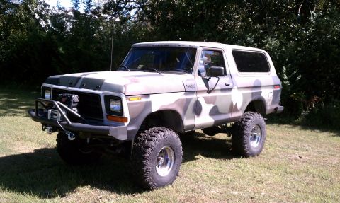 1979 Ford Bronco - This lifted Ford Bronco features a camouflage paint scheme and a heavy-duty front bumper.