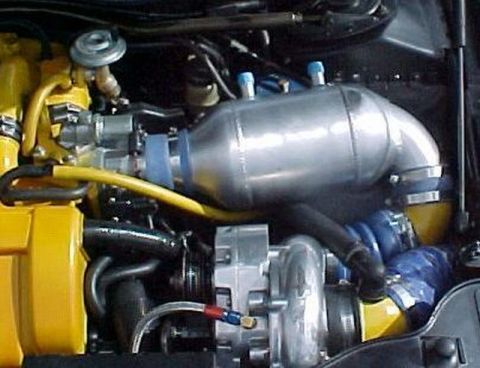 1997 Ford Taurus - Close-up of an engine bay with aftermarket turbocharger and intercooler components.