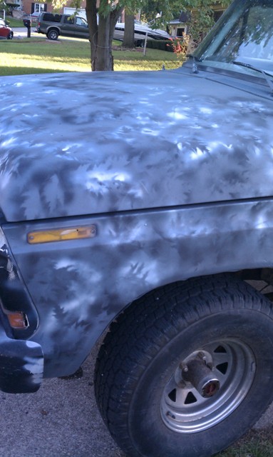 1978 Ford Bronco - The hood and fender of a truck show a unique, abstract paint pattern.