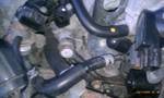 1994 Ford Probe - A close-up view of various hoses and connections within a vehicle's engine bay.