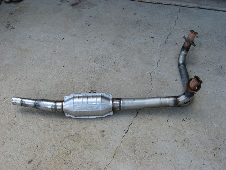 Exhaust pipe assembly with catalytic converter. Shows pipes and flanges