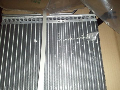 1994 Ford Bronco - Close-up view of the fins on a vehicle's AC system component.