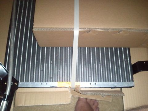 1994 Ford Bronco - A close-up view of a vehicle's AC condenser unit, secured within its packaging.