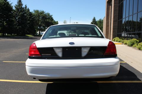 2003 Ford Crown Victoria - Rear view of a white 2003 Ford Crown Victoria parked in a lot.