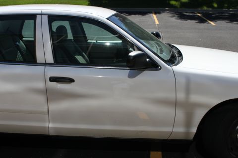 2003 Ford Crown Victoria - Side view of a white 2003 Ford Crown Victoria sedan parked in a lot.