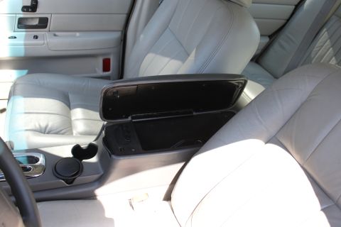 2003 Ford Crown Victoria - Interior view of a 2003 Ford Crown Victoria, highlighting the front seats and center console storage.