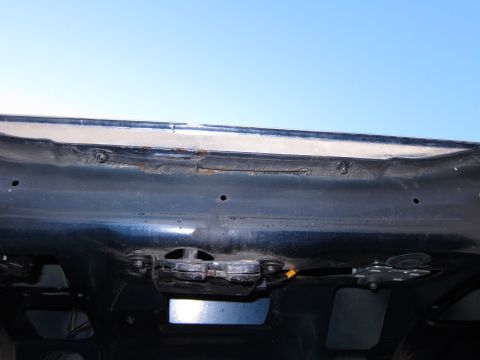 1991 Ford LTD Crown Victoria - Close-up of the trunk latch mechanism on a 1991 Ford Crown Victoria LTD, showing some rust.