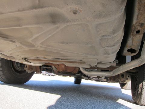 1991 Ford LTD Crown Victoria - Underside view of a car, revealing the fuel tank and exhaust components.