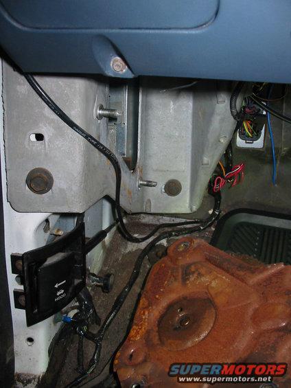 1993 Ford F-150 - This image shows the underside of a vehicle's dashboard with exposed wiring and a large, rusty component.