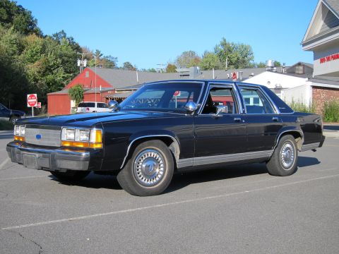 1991 Ford LTD Crown Victoria - This 1991 Ford Crown Victoria LTD sedan is seen from a three-quarter front view in a parking lot.