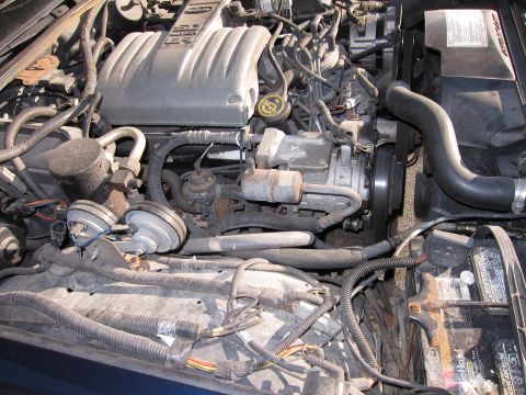 1991 Ford LTD Crown Victoria - A close-up view of a car's engine bay, showing various mechanical parts and wiring.