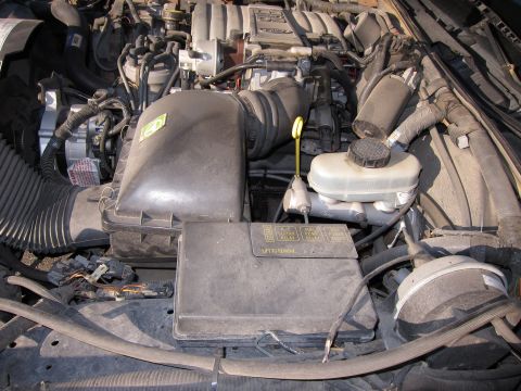 1991 Ford LTD Crown Victoria - Close-up view of a car's engine bay, showing various components and wiring.