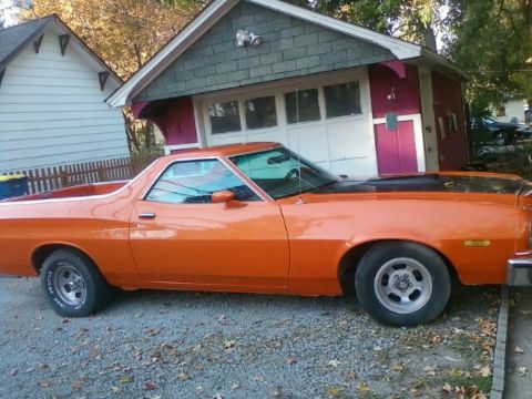 1975 Ford Ranchero - This 1975 Ford Ranchero is seen from the side, parked in front of a garage.