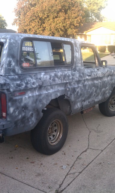 1978 Ford Bronco - This 1978 Ford Bronco is seen from the side, a unique camouflage-style paint job and a sticker on the rear window.