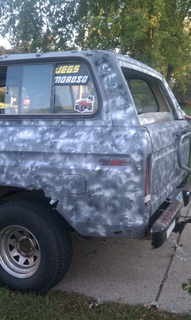 1978 Ford Bronco - The rear of a 1978 Ford Bronco with a camouflage paint job and a JEGS sticker on the rear window.