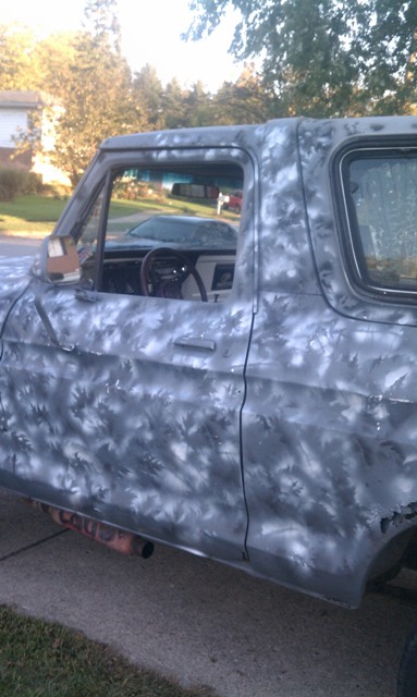 1978 Ford Bronco - Side view of a 1978 Ford Bronco showing its interior and custom camouflage paint job.