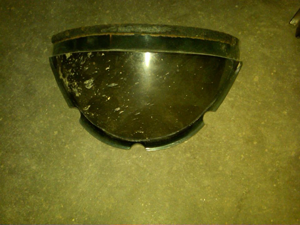 Dark green headlight bezel with chipped paint