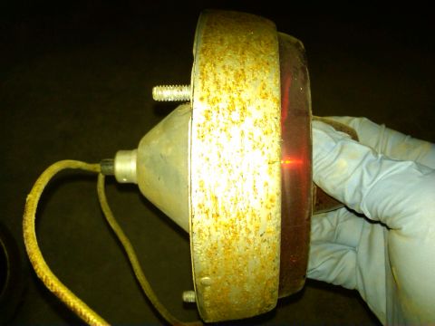 1954 Ford Customline - Close-up of a rusty tail light assembly, likely for an older vehicle.
