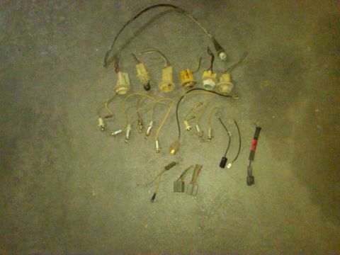 1954 Ford Customline - A collection of vintage automotive electrical components, including wiring harnesses and sockets, laid out on a textured surface.