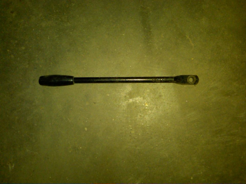 Black metal rod with black knob on one end and a hole on the other