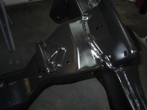 1973 Pontiac Trans Am - A close-up view of a vehicle's frame, showing welded seams and mounting points.