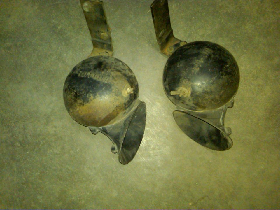 Pair of old car horns with visible text on one
