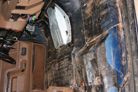 1989 Ford Bronco - The interior of the vehicle shows significant wear and tear, with exposed wiring and rust evident.