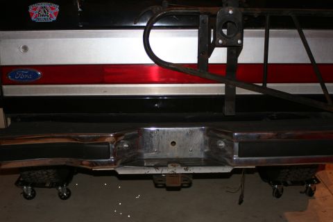 1989 Ford Bronco - The rear of a Ford Bronco shows a chrome bumper and a spare tire carrier mounted on the tailgate.